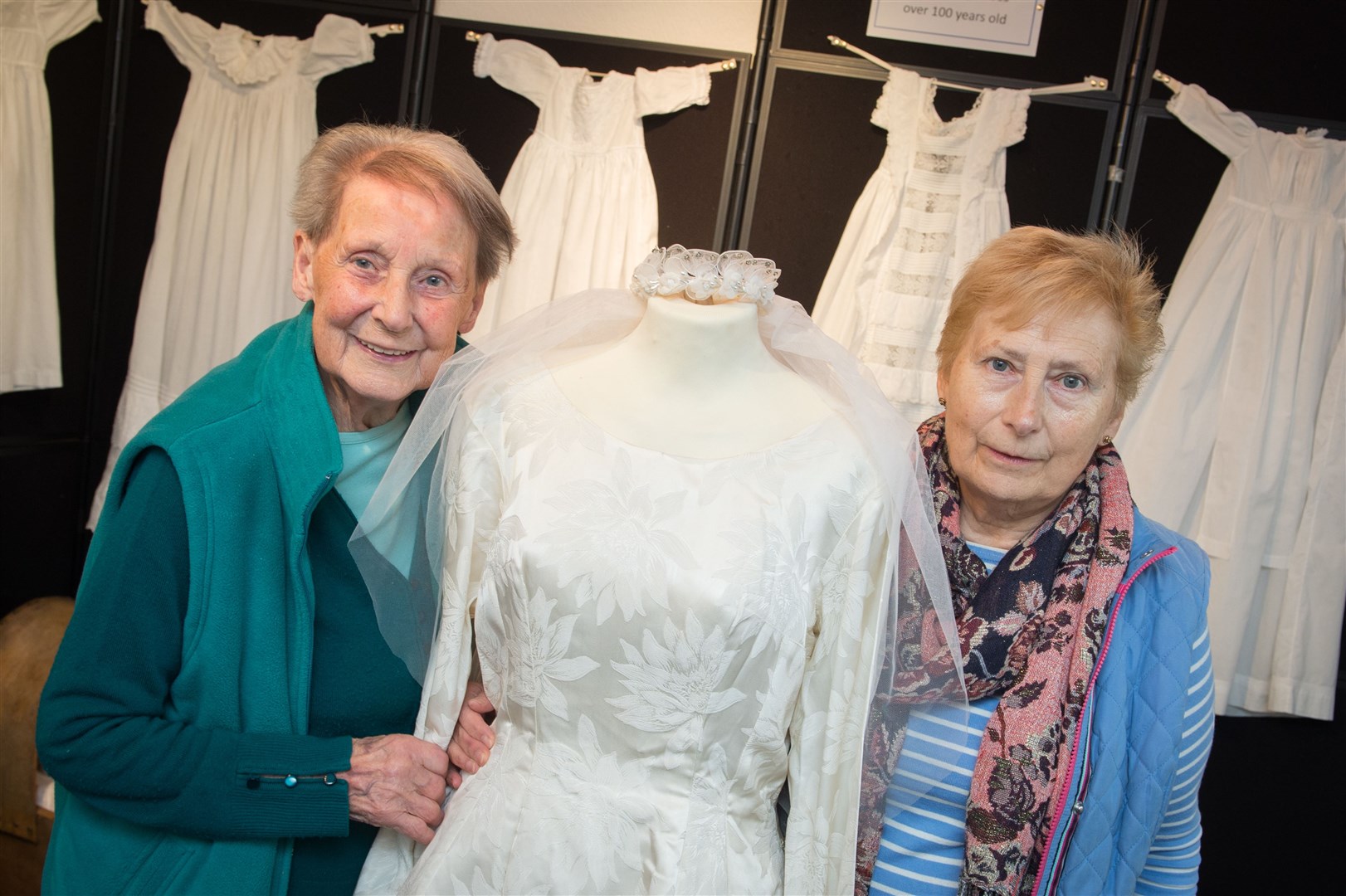 Irene Bell and Shona Gray with a wedding dress from the 1960's with some christening robe's in the backgroundPicture: Callum Mackay. Image No. 033353
