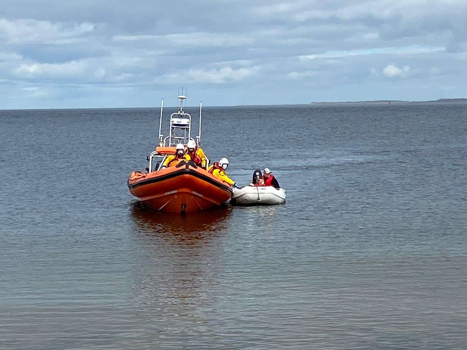 The RNLI lifeboat tows the boat to the shore. Picture: Martin Hier.