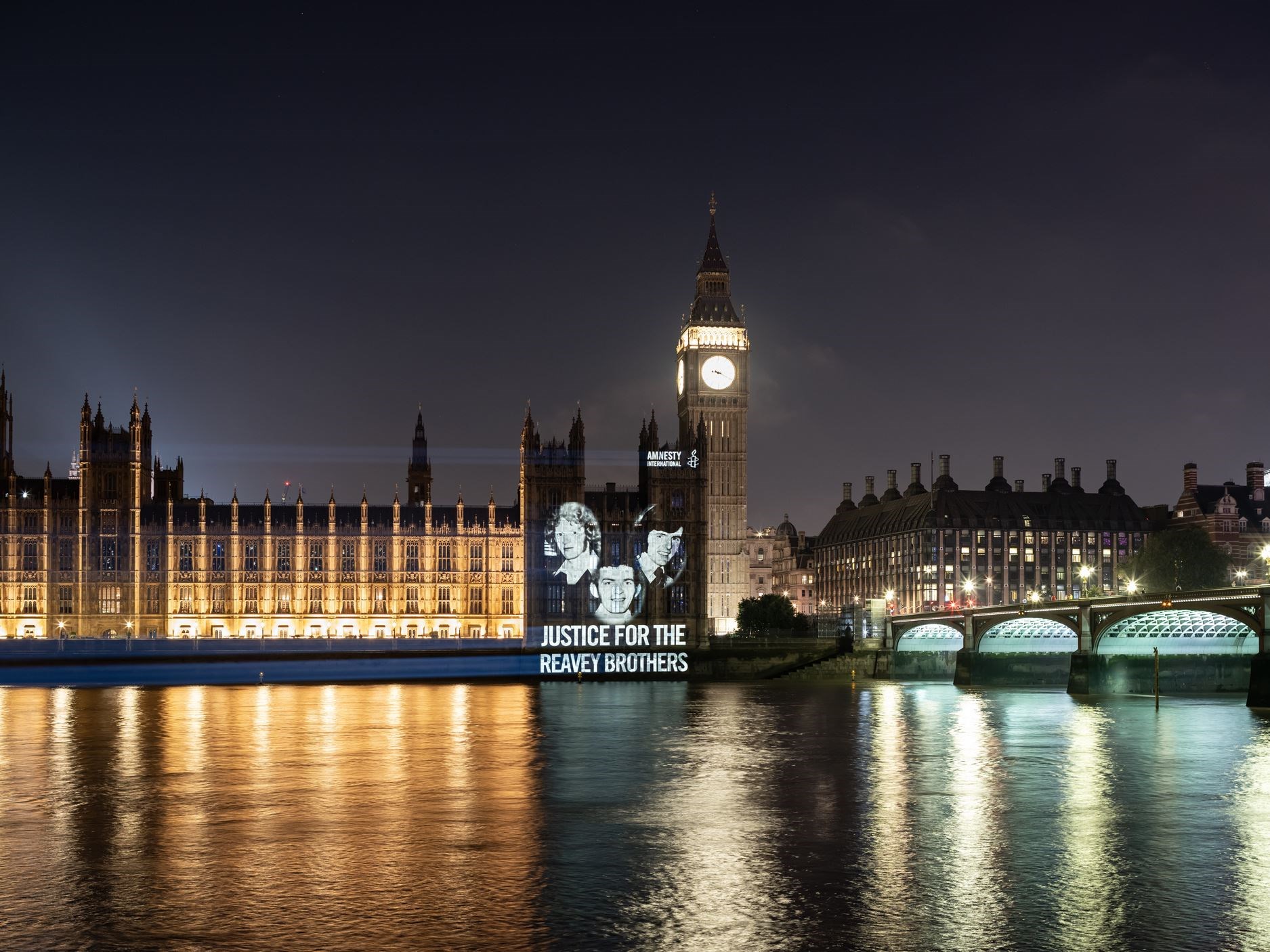 The image of the Reavey brothers projected onto Parliament (Amnesty International/PA)