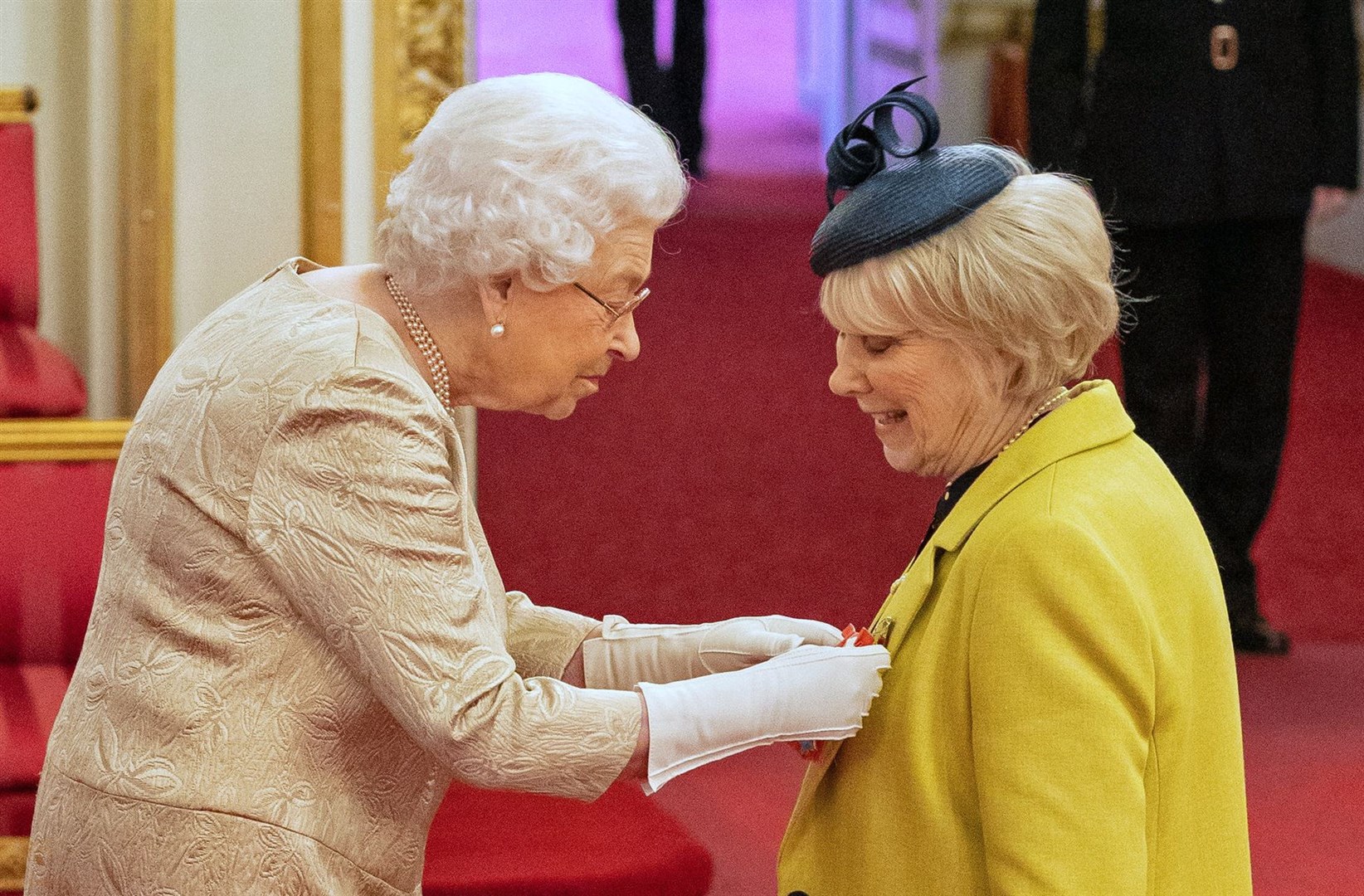 The Queen was pictured wearing gloves for the first time at a palace investiture in March last year (Dominic Lipinski/PA)