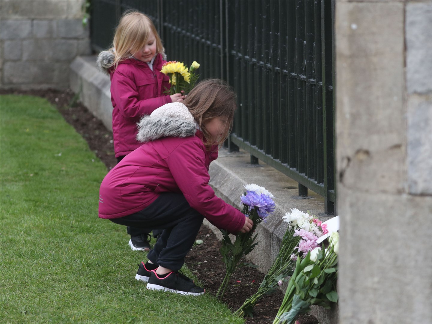 Elaine and Maya (left) Jamieson from Berkshire, leave flowers outside Windsor Castle (Steve Parsons/PA)