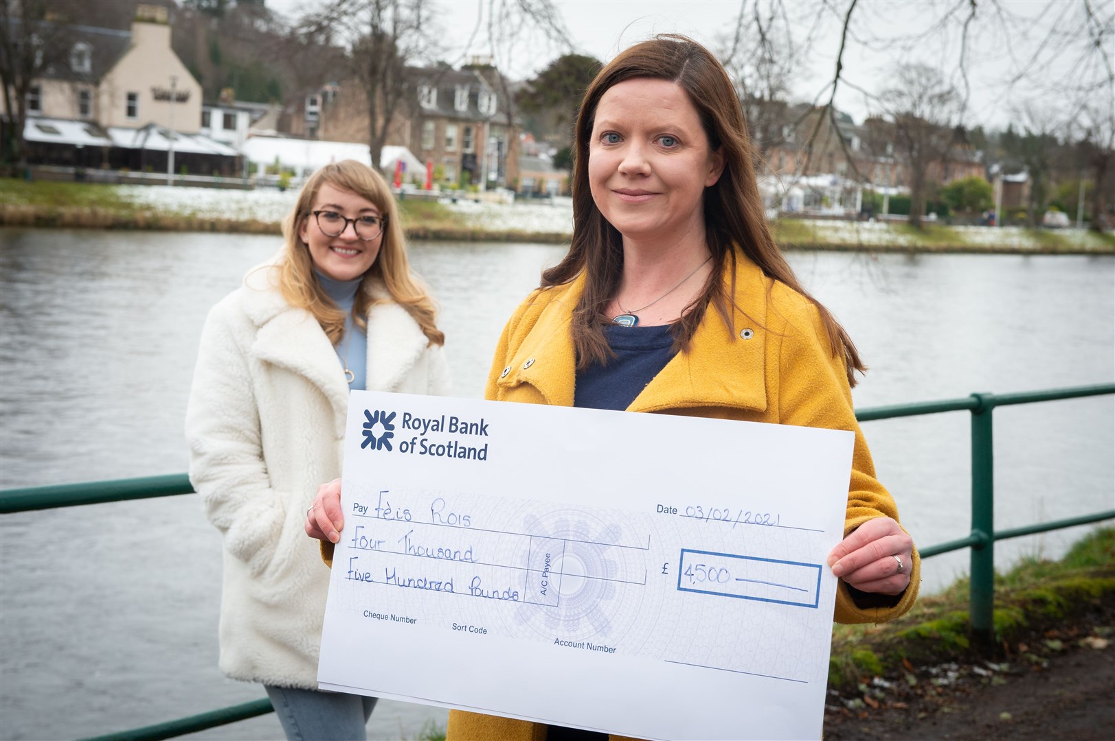 Highland Business Women president Màiri Macdonald (left) presents Fèis Rois chief executive Fiona Dalgetty with a cheque for the funds raised for the charity over the last year.