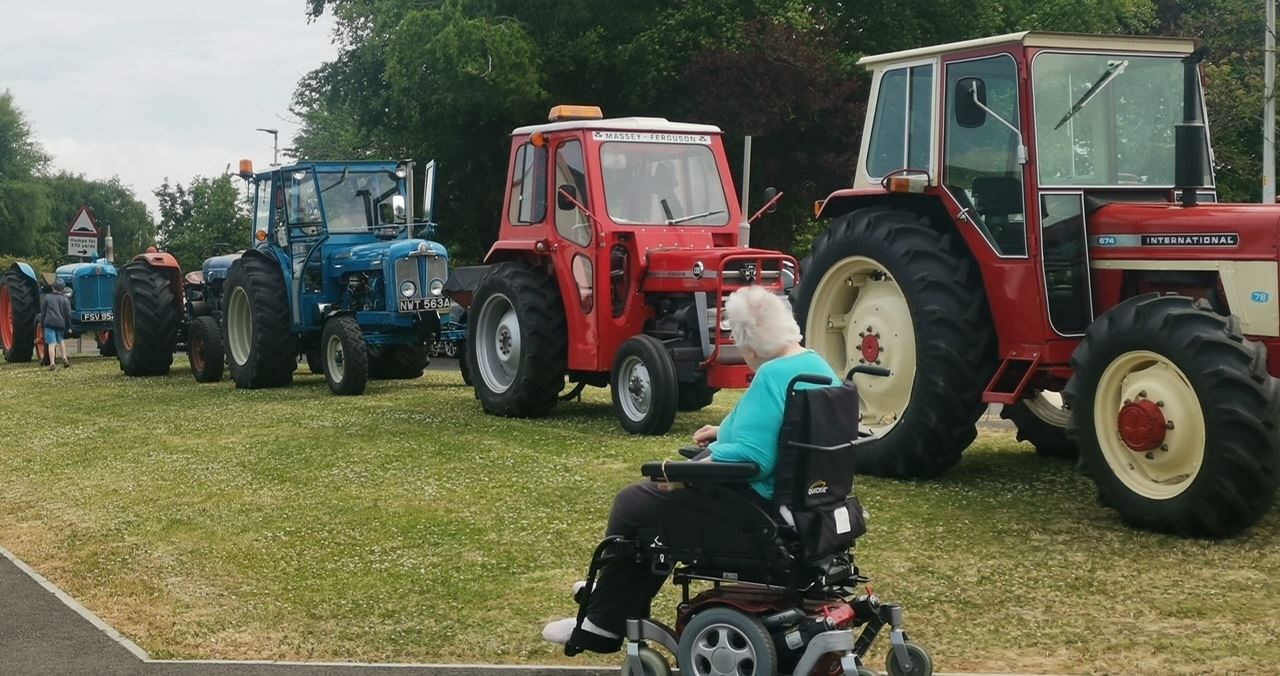 Pauline Mackay admiring the tractors. Eilean Dubh Care Home