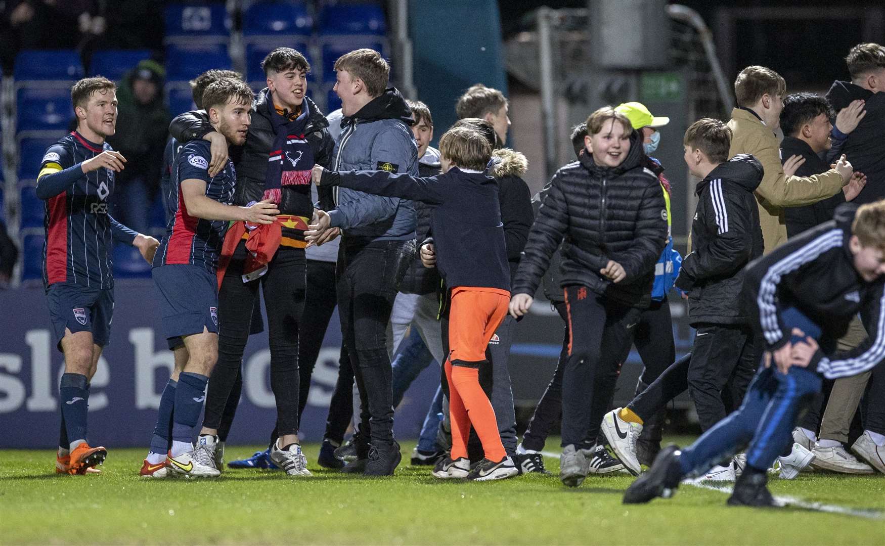 Fans invaded the pitch at the Global Energy Stadium after Regan Charles-Cook put Ross County 2–1 up against Motherwell on Tuesday night. Picture: Ken Macpherson