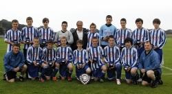 Alness United receiving the SWL Under-17 championship with David Wilson in the middle.