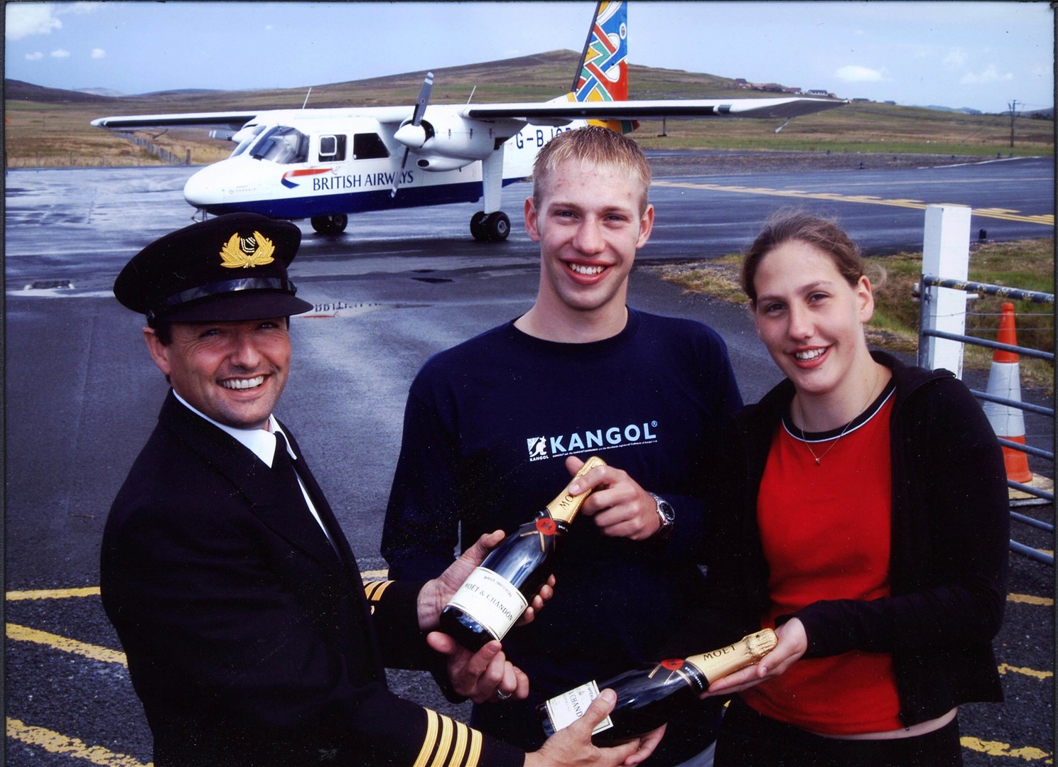 Loganair Captain Eddie Watt with David Henderson, Lynsey Henderson presenting a gift on their 21st birthday.