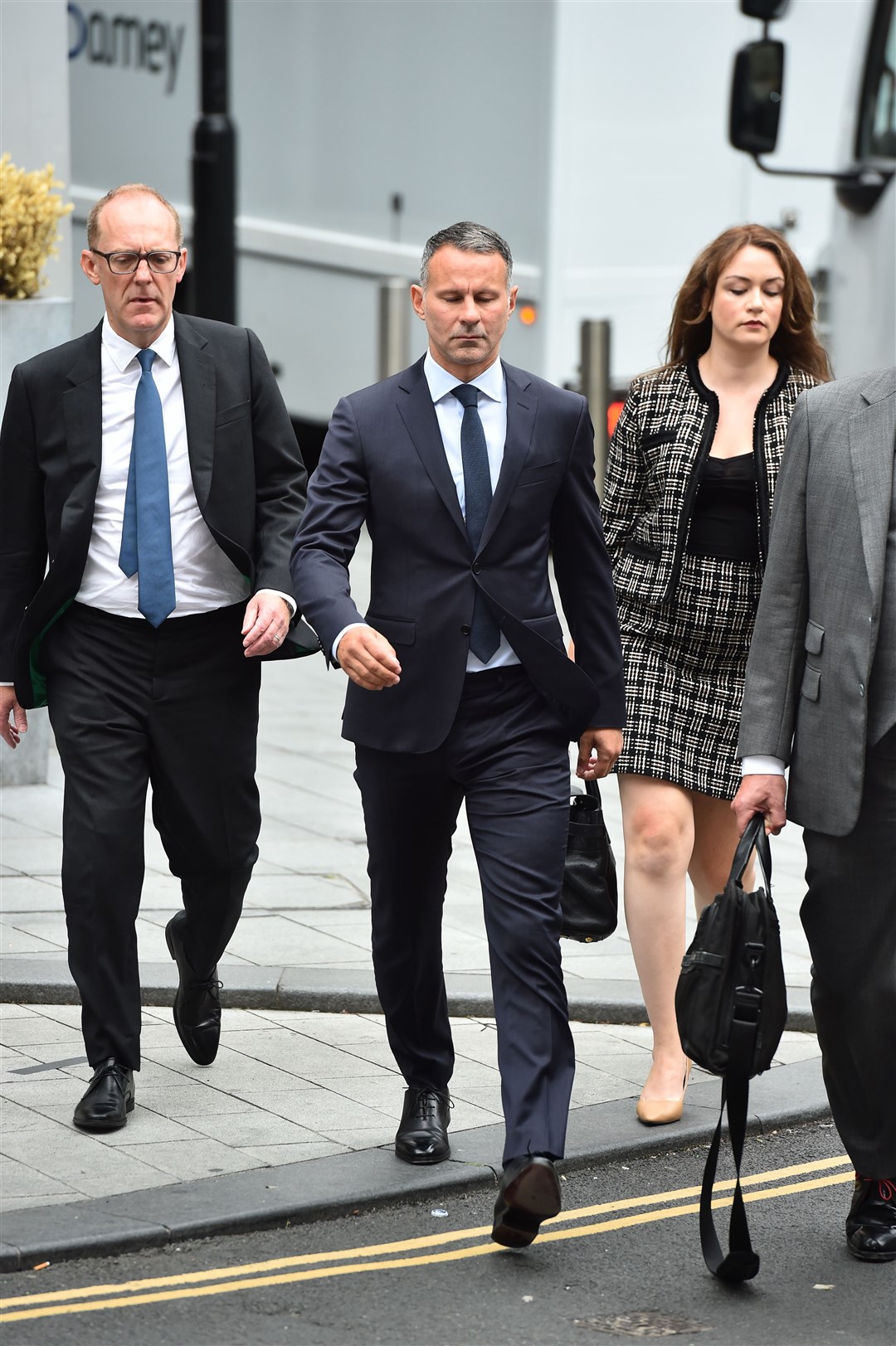Former Manchester United footballer Ryan Giggs (centre) arrives at Manchester Crown Court (PA)