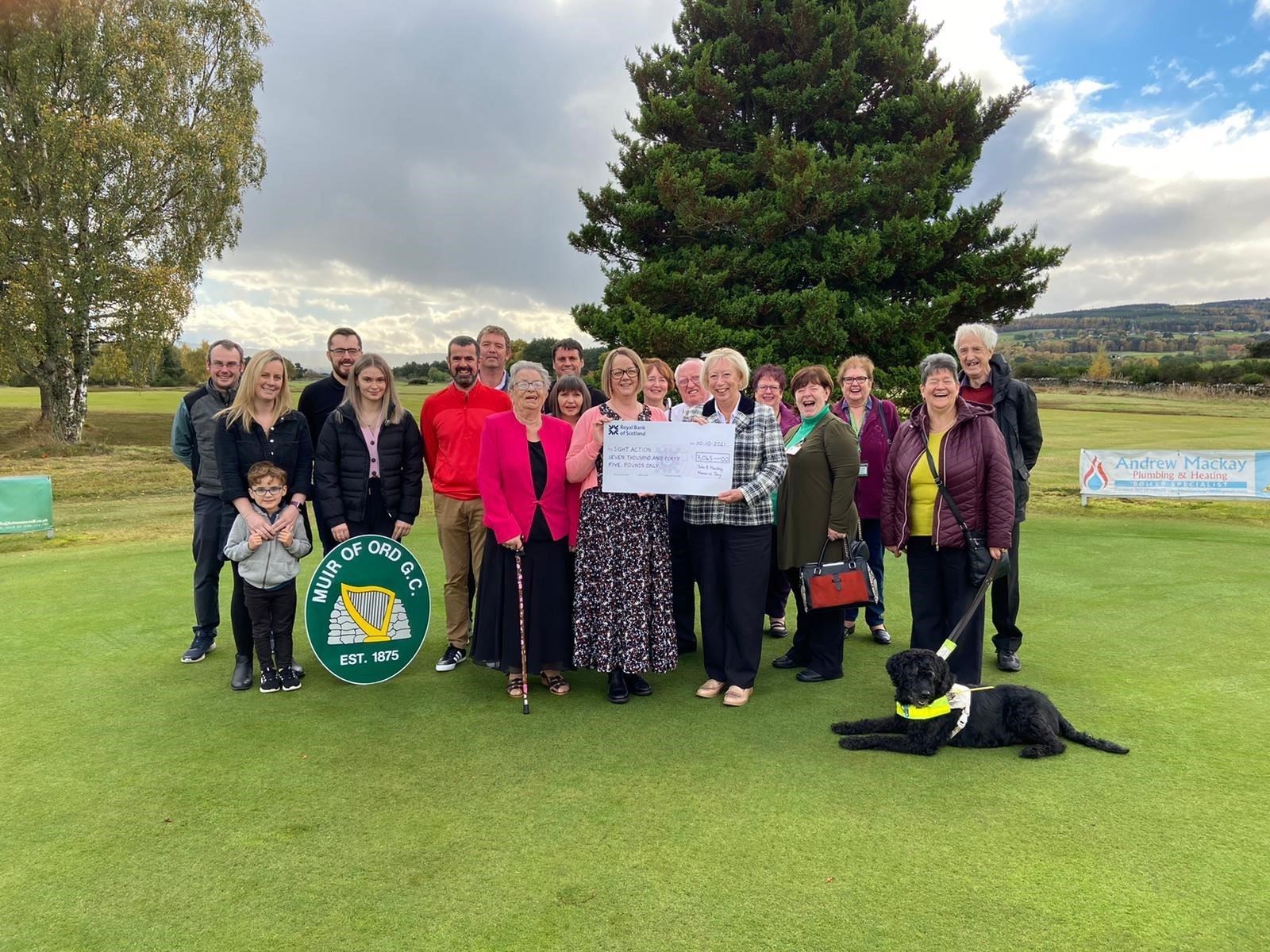 The golf club presenting Sight Action with the cheque.