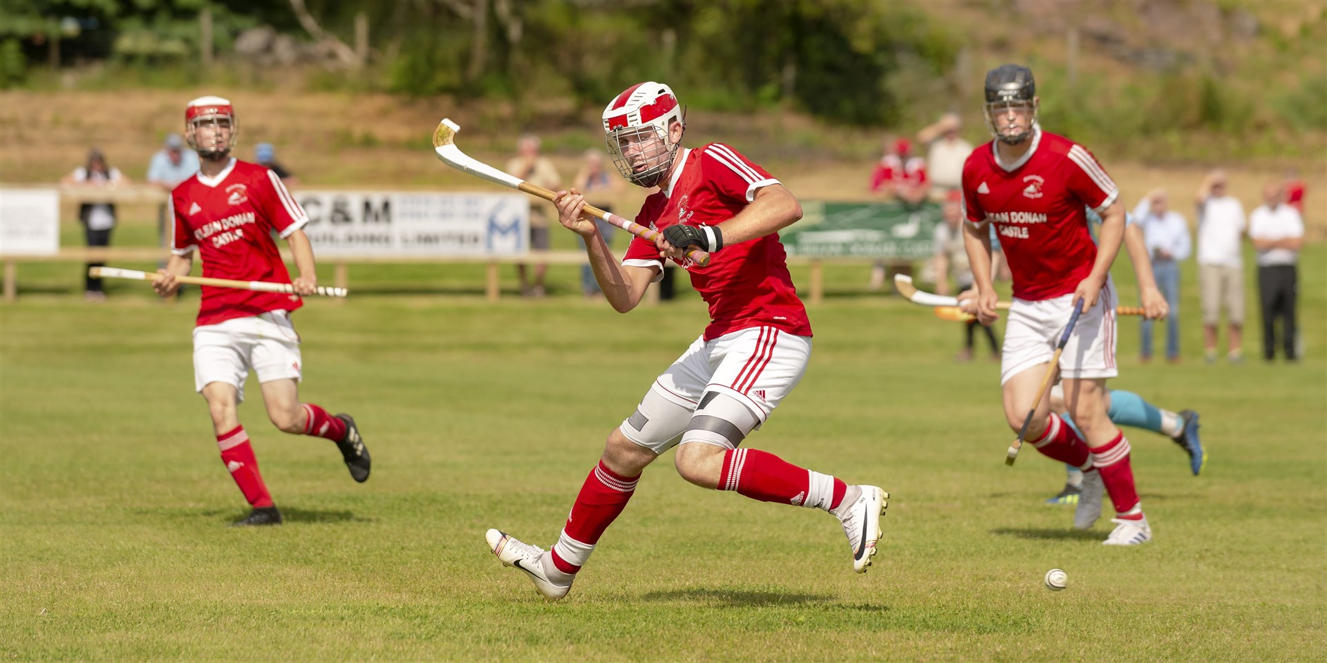 Kinlochshiel’s Donald Nixon (centre) and team mates enjoy the new playing surface at Reraig, Balmacara. Picture: Neil Paterson