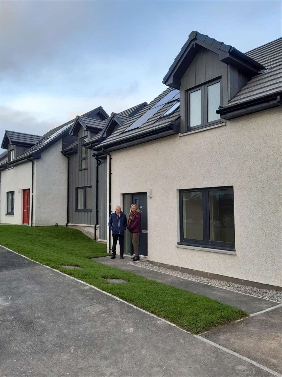 Pictured outside one of the new homes are Councillor Ian Cockburn and acting principal housing officer, Janice Neil.