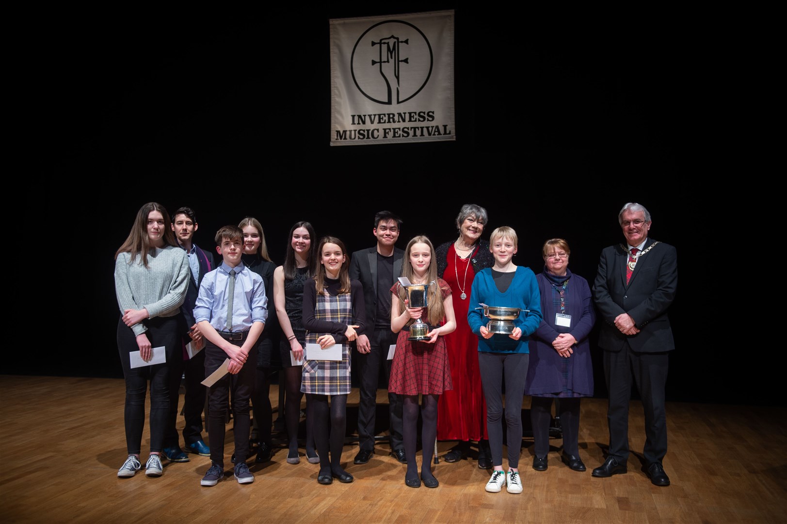All the Premiere Competition finalists with, from left, Ros Hill, festival chairwoman Jean Slater and Depute Provost Graham Ross and the end of this year's Inverness Music Festival. Picture: Callum Mackay