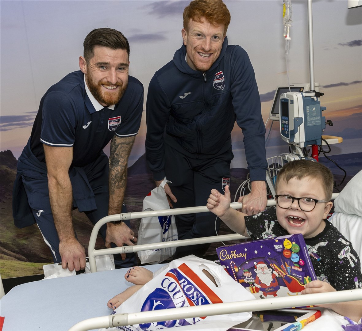 (from left to right) Jack Baldwin and Simon Murray pictured with a patient in the Highland Children’s Unit. Picture: Ken Macpherson