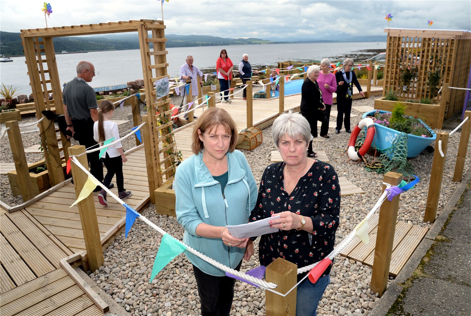 Pictured at the ticket office garden with the letter from the council chief executive are North Kessock residents.Jackie Patience (front right) and Maggie MacDonald who is the chairwoman of NKTOP, North Kessock Ticket Office Project....Bottle bank objectors.Picture: Gair Fraser. Image No. 044414..