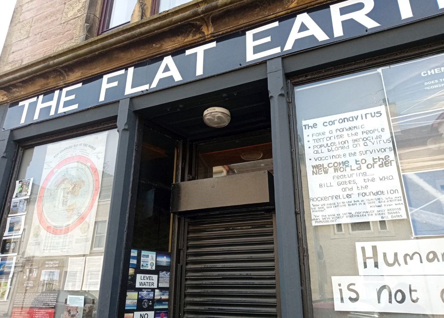 The notice in the Flat Earth window in Greig Street.