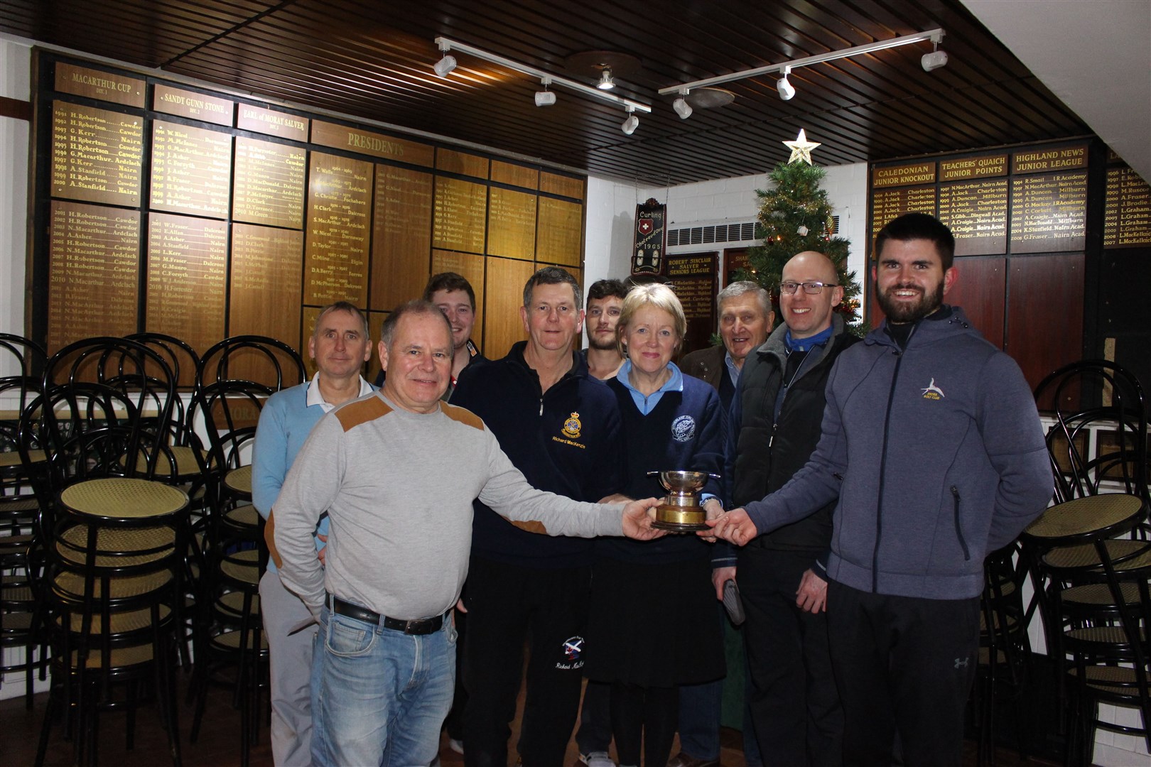 Finlay MacKenzie (President of Ross-shire Province) hands over the trophy to the Locheye/Invergordon curlers left to right Richard MacKenzie Helen Lyon, Roy Watson and Calum Stewart.