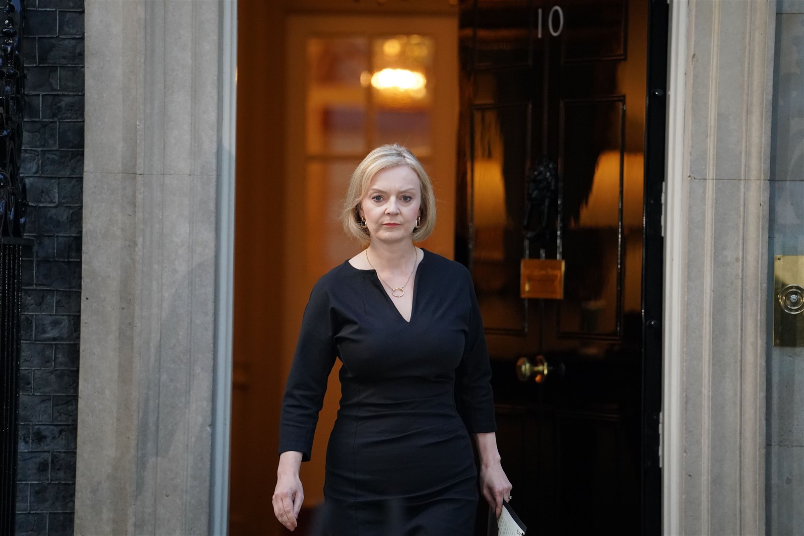 Prime Minister Liz Truss walks from the door of 10 Downing Street, London, to read a statement following the announcement of the death of Queen Elizabeth II (Dominic Lipinski/PA)