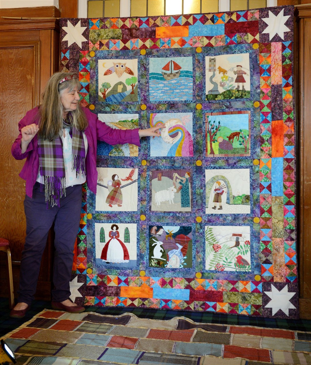 Artist and storyteller Lizzie McDougall with her Ceilidh Quilt.