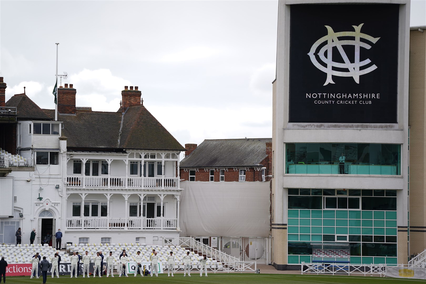 Durham CCC players stand for a minute’s silence as the flag is flown at half mast at Trent Bridge in Nottingham (Zac Goodwin/PA)