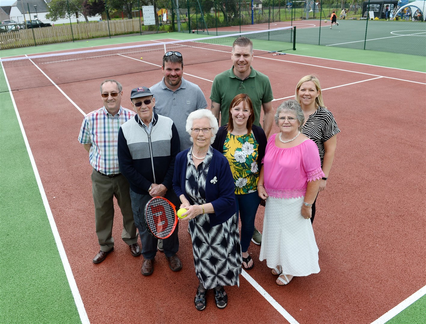 Honour of first serve on new court went to Moira Reid (82), five times winner of Avoch championship with representatives of Avoch Amenities Association, councillors and representatives of Rosehaugh Estate.. Picture: Gary Anthony. Image No.044150