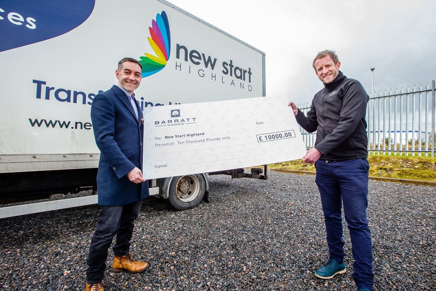 James Dunbar, of New Start Highland, receives a cheque from Alan Fraser, construction manager for Barratt Homes.