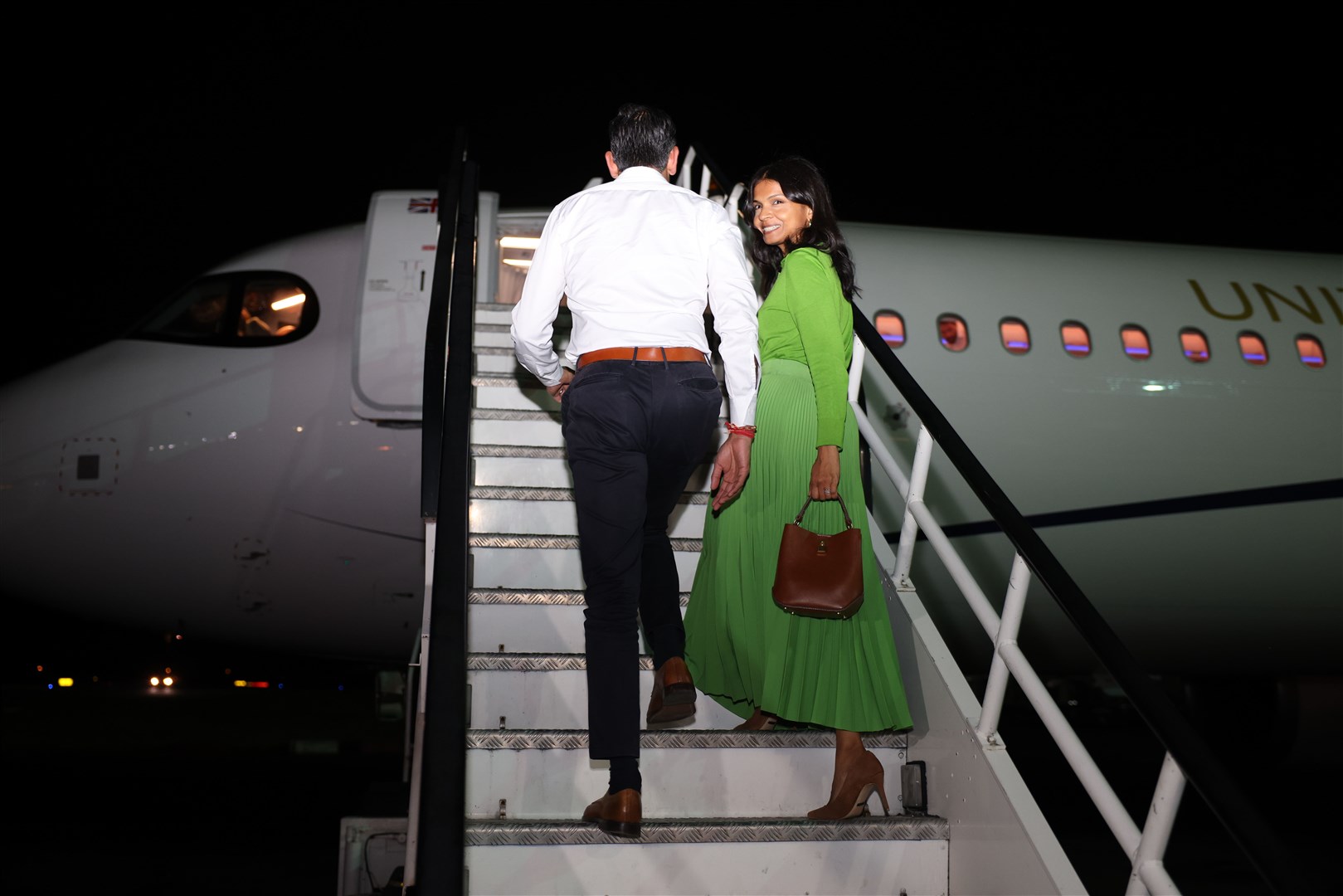 Rishi Sunak and his wife Akshata Murthy board the plane for India (Dan Kitwood/PA)