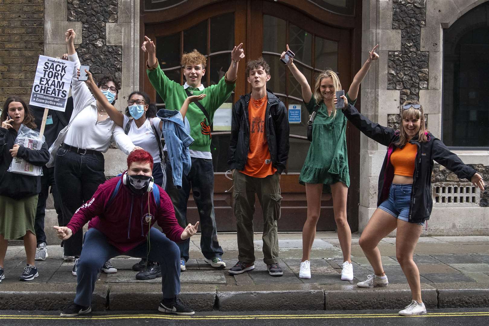 Students celebrate outside the Department for Education after the U-turn on A-levels (Victoria Jones/PA)