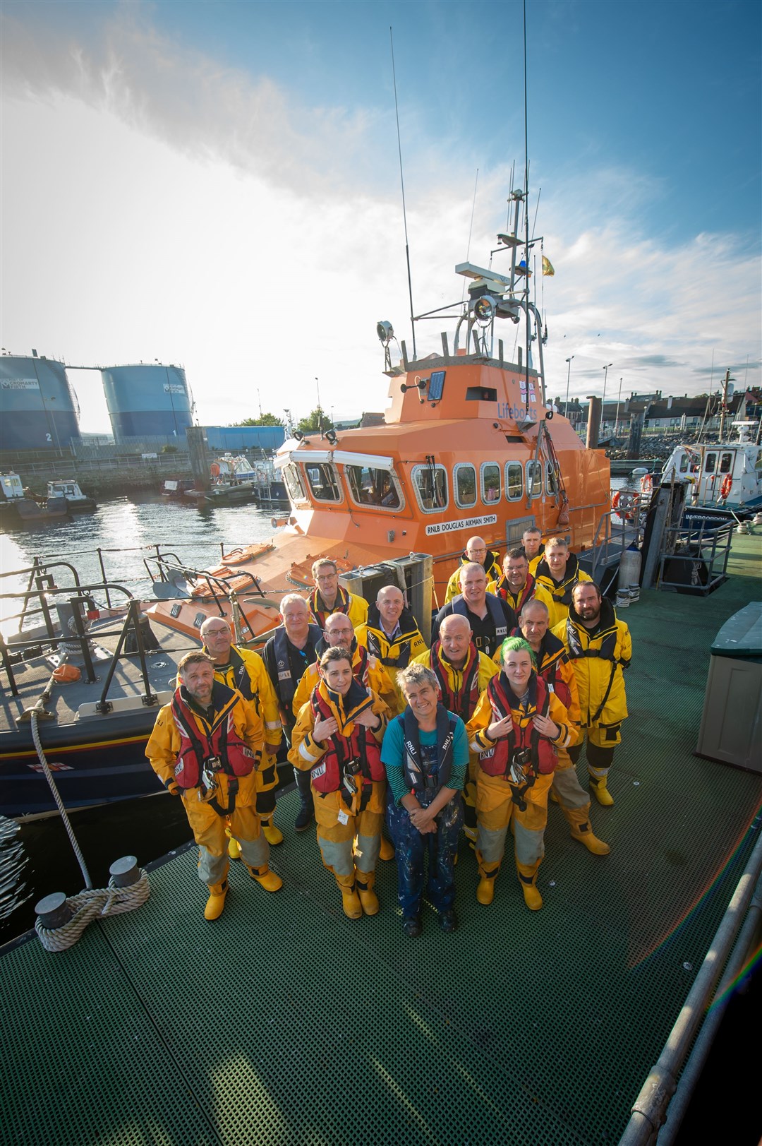 Flashback to happy days when mural artistTracey Slough (centre) paid a visit to the Invergordon crew in 2019. The image of the lifeboat is on the town's mural trail. Picture: Callum Mackay.