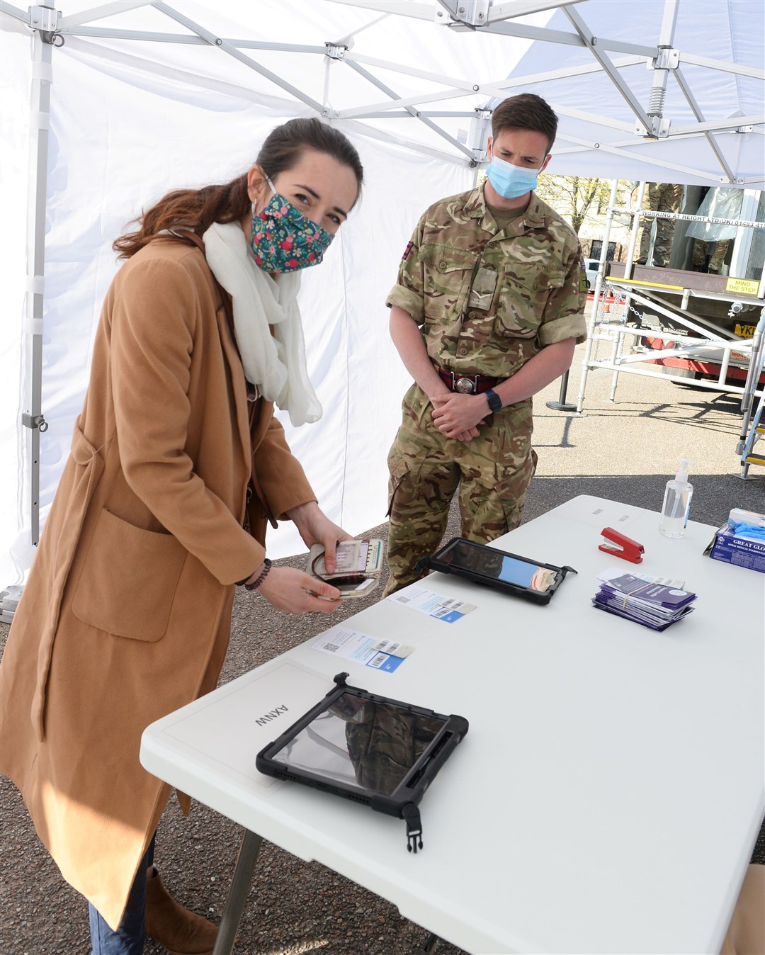 Courier reporter Federica Stefani registering to get her test, with help from LCpl Law of 39 Engineer Regiment.