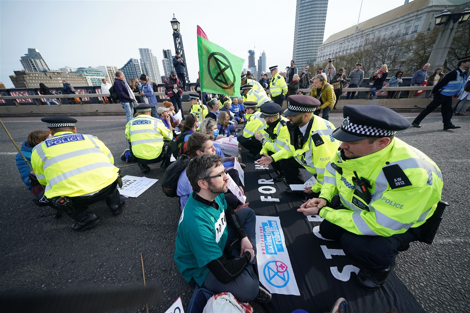 Police talk to protesters taking part in a demonstration on Lambeth Bridge in central London (Yui Mok/PA)