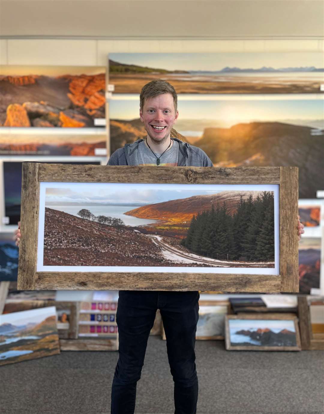 Jack Marris with one of his photos framed in recycled poles.