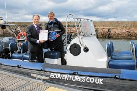Scott Armstrong of VisitScotland presents Cromarty-based EcoVentures' owner Sarah Pern with the highest quality award.