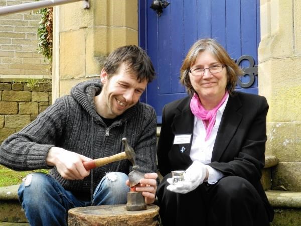 Jason Ubych, a volunteer at Tain & District Museum, practises his metalworking skills as assistant manager, Sheila Munro, shows him a Hugh Ross I thistle cup.
