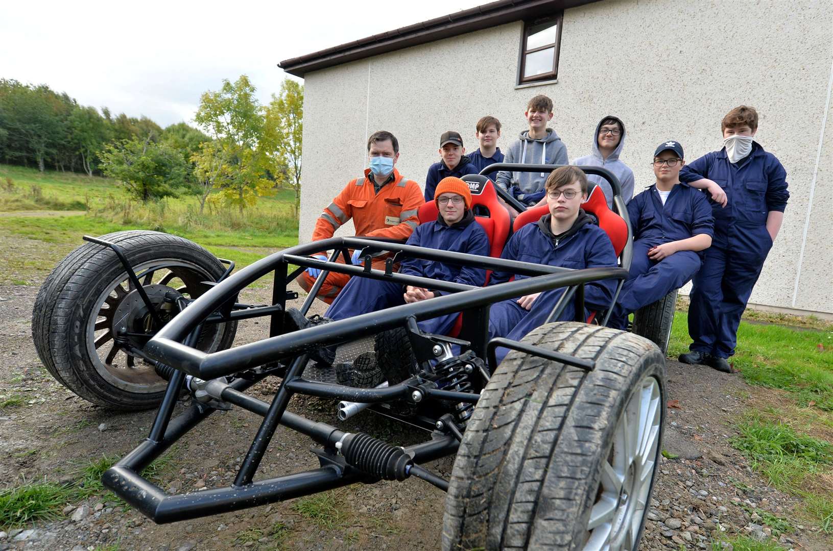 Training Manager Peter Doherty with some of the young people with a kit car which will be built from scratch.