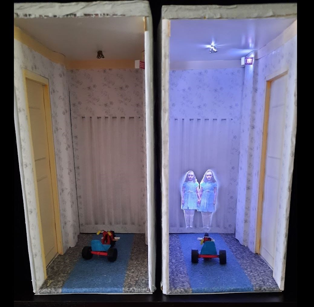 The Shining book nook without and with a light on the twins (Janet Edgecomb Roller/PA)