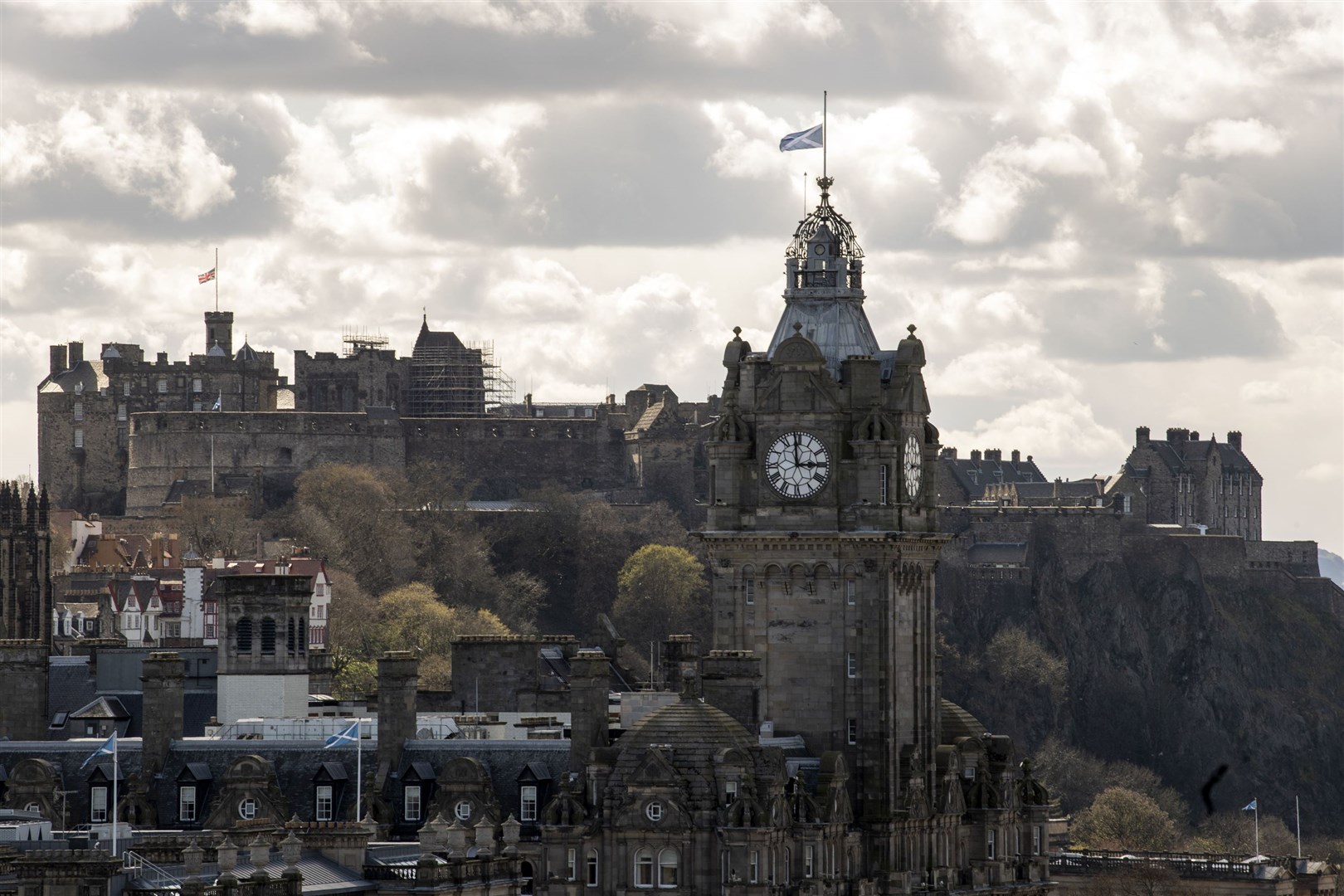 The Union flag above Edinburgh Castle and the flag of Scotland on the Balmoral clock in Edinburgh flying at half mast (Lesley Martin/PA)