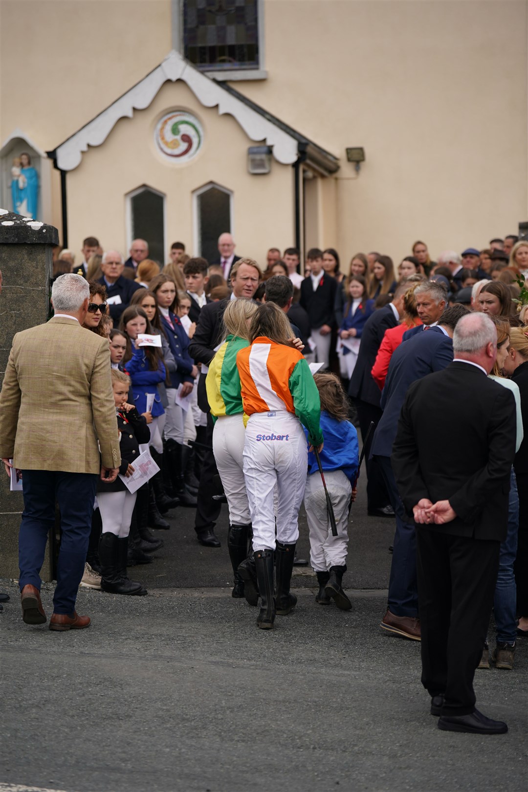 Young jockeys arrive for the funeral of Jack de Bromhead (Niall Carson/PA)