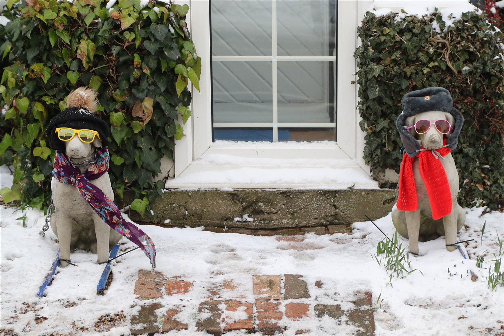 Ornamental dogs dressed for the snow in Minster, Kent (Gareth Fuller/PA)