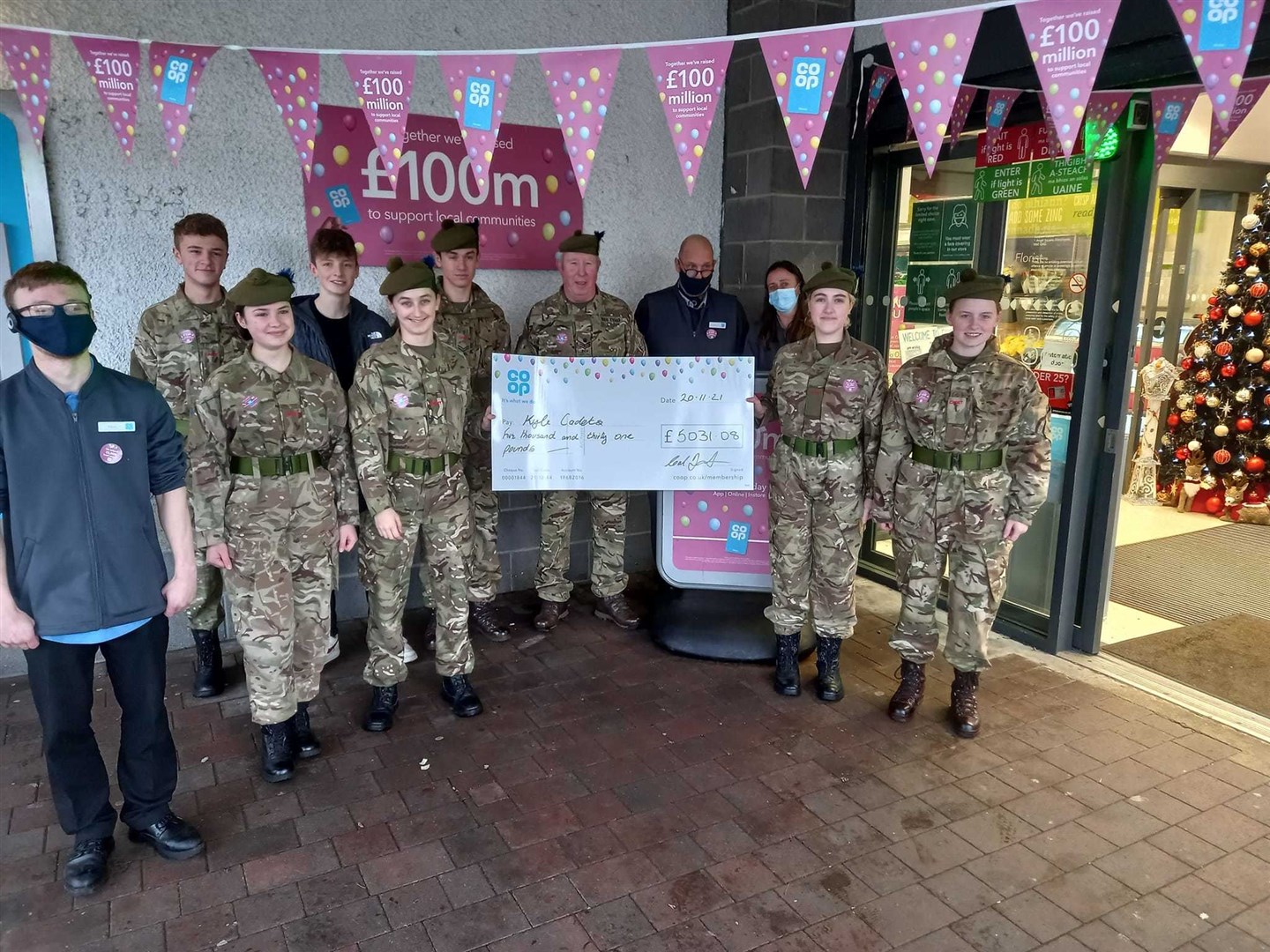 Kyle detachment accepting a cheque for £5031 raised by the Co-op members of Kyle of Lochalsh.