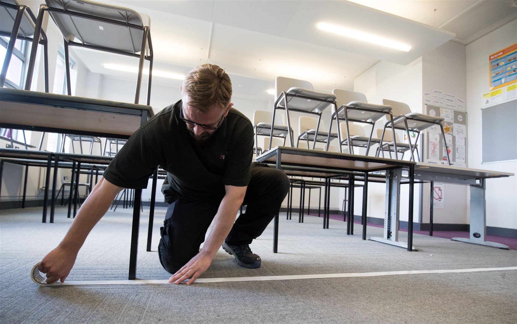 A boundary line is taped to the floor in a classroom at Ark Charter Academy in Portsmouth, as preparations are made before the start of the new term (Andrew Matthews/PA)