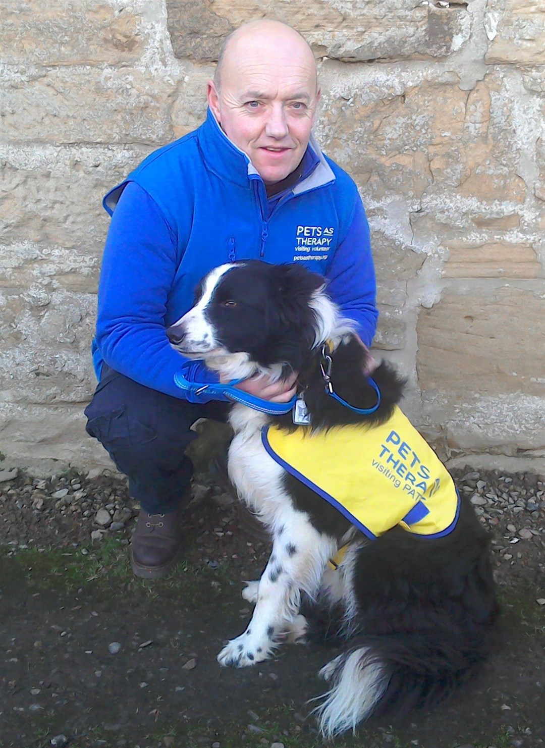 Adrian Munro, area coordinator for the Highlands, with pet therapy dog Bobby.
