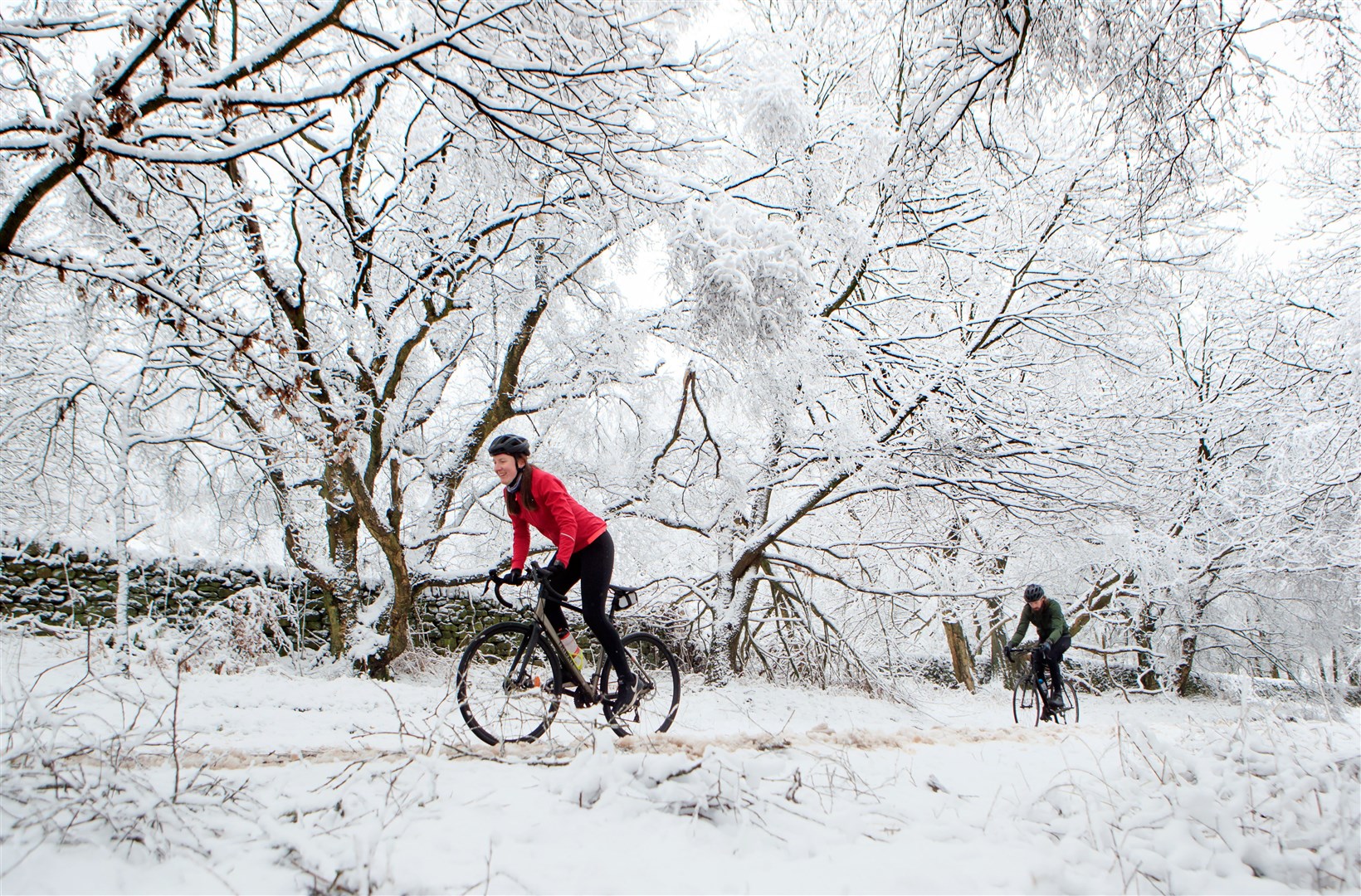 Cyclists in snowy conditions near Bradfield Dale, South Yorkshire (Danny Lawson/PA) 