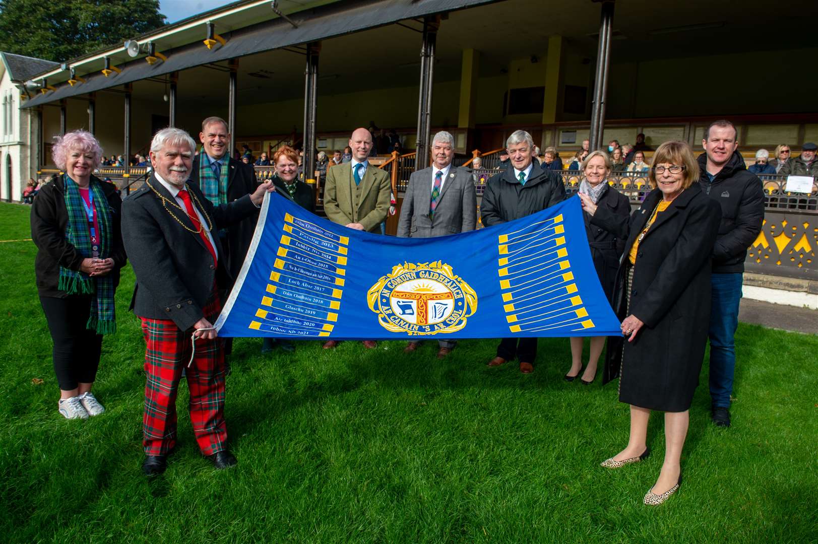 Royal National Mod, Massed Choirs Event at The Northern Meeting Park. Depute Provost Cllr Bet McAllister, right, hands over the mod to Perth and Kinross Provost Dennis Melloy, left. Picture: Callum Mackay