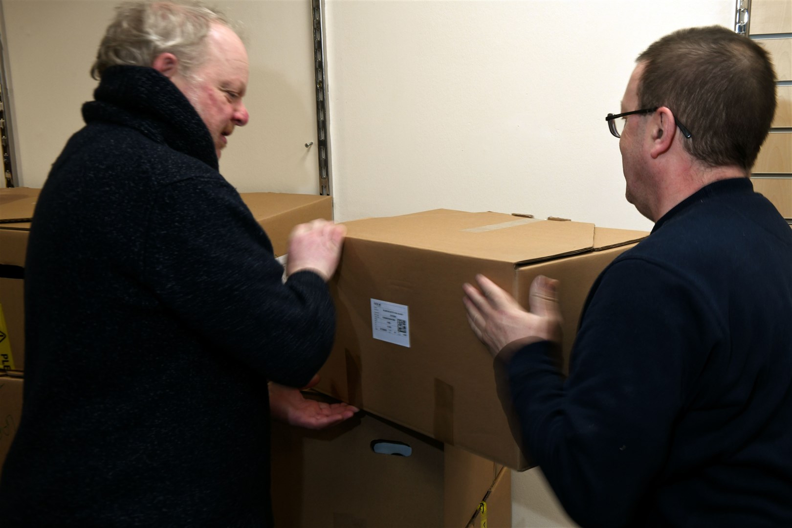 Easton Thain and Hamish Fraser packing up the boxes of stock that are to go to other charity shops.