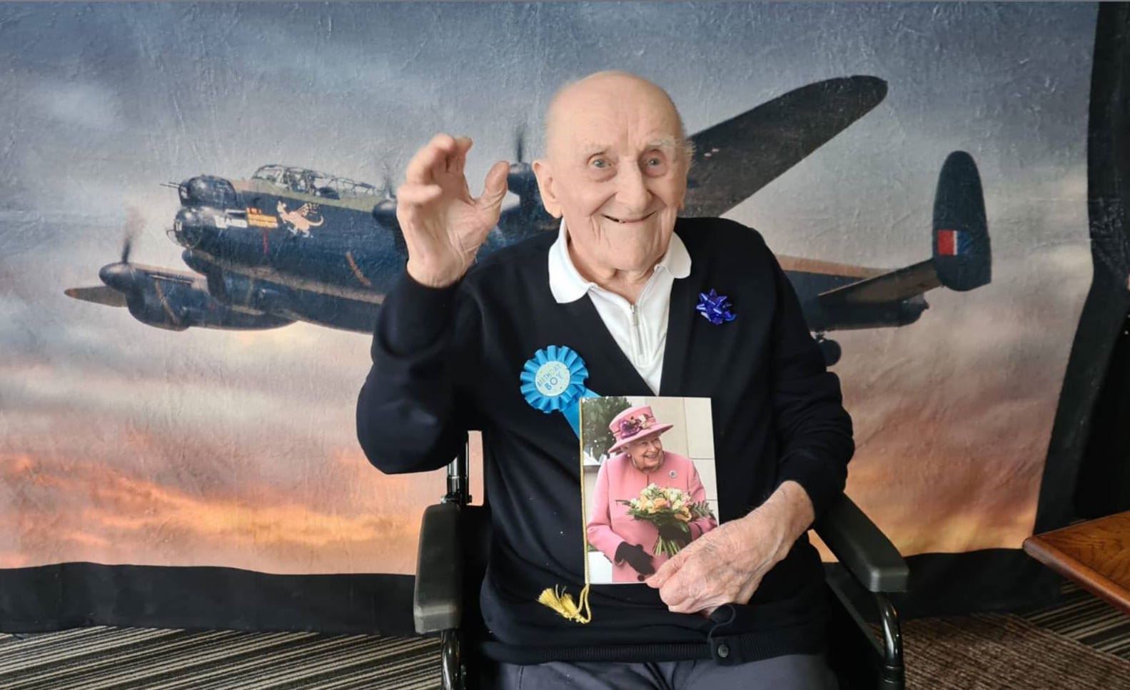 James Crook (100) with the birthday card from the Queen that he is now able to read thanks to help from the charity.
