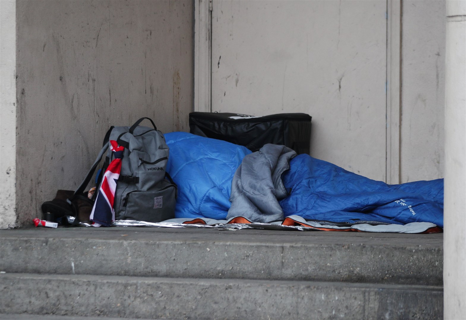 A homeless person sleeping rough in a doorway (PA)