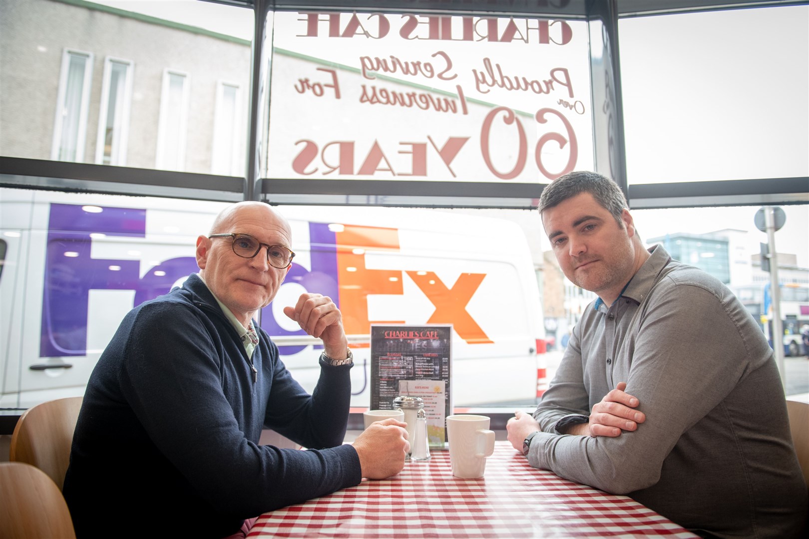 Martin Pieraccini (left) enjoys a cuppa with Chris Corbett, the new owner of Charlie's Cafe.