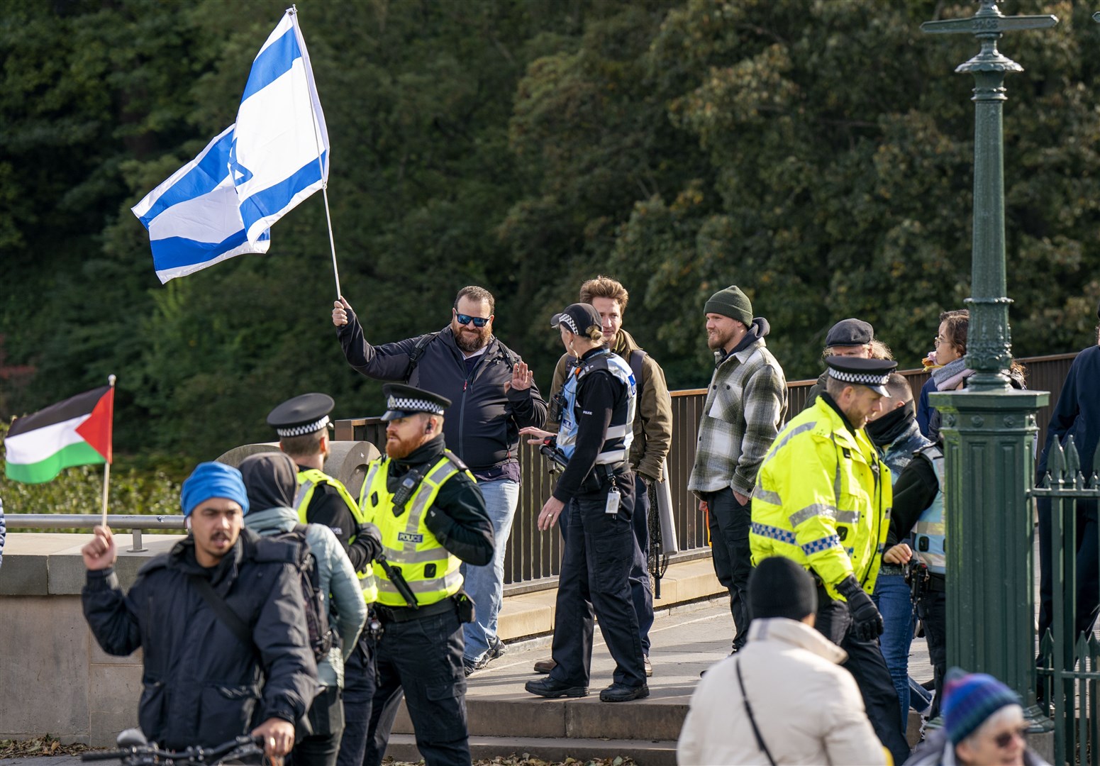 A man flies an Israeli flag during a Scottish Palestine Solidarity Campaign demonstration in Edinburgh (Jane Barlow/PA)
