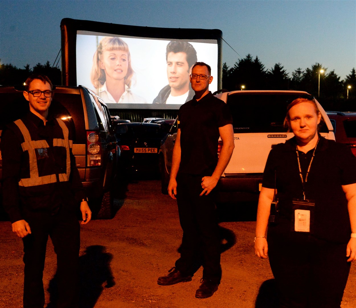 Staff William Porter, Gerard Paton and Sammy Macneill helped make sure everyone got parked where they could see the screen. Picture: James Mackenzie