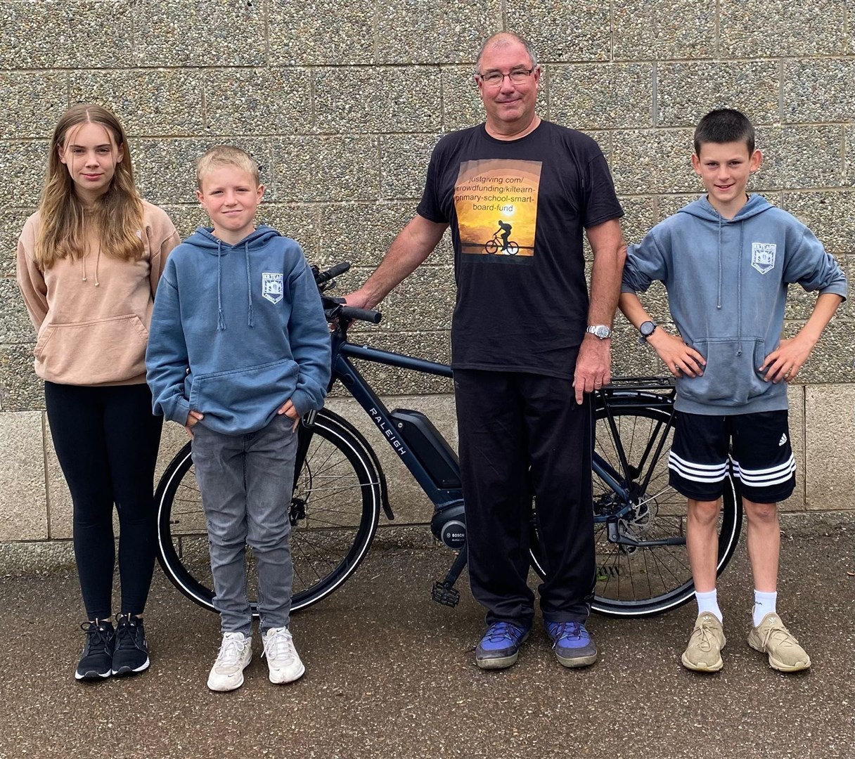 Andrew Newton with Kiltearn Primary pupils before he set off on his cycle ride.