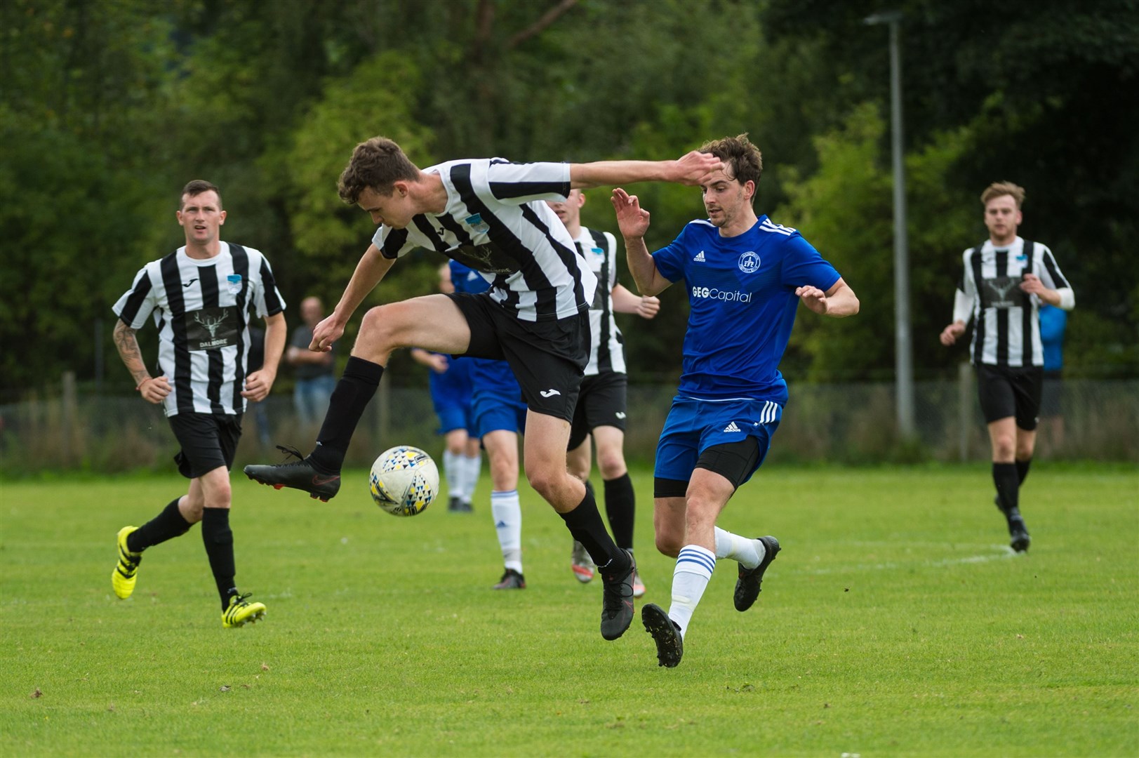 Alness United defender Gregor Patterson tries to clear the ball. Picture: Callum Mackay